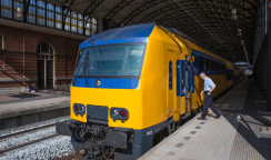 Conductor getting in a train ready to start in The Hague, the Netherlands