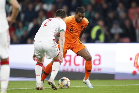 Georginio Wijnaldum attempting to pass Belarus striker Stanislav Dragun.